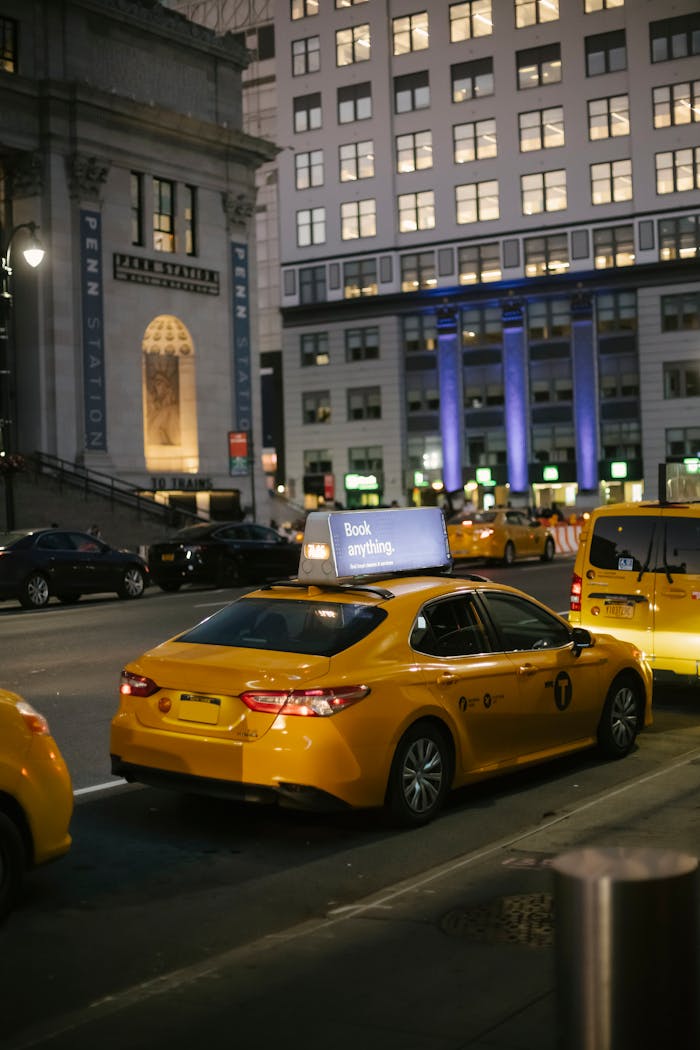Crafting Captivating Headlines: Your awesome post title goes here Urban scene on a New York street at night featuring yellow taxis in front of Penn Station.